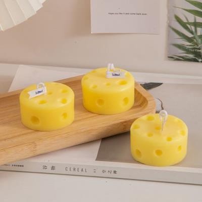 Picture of ROUND CHEESE SHAPE CANDLE.
